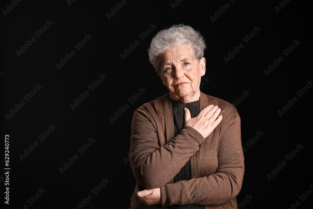 Senior woman on black background