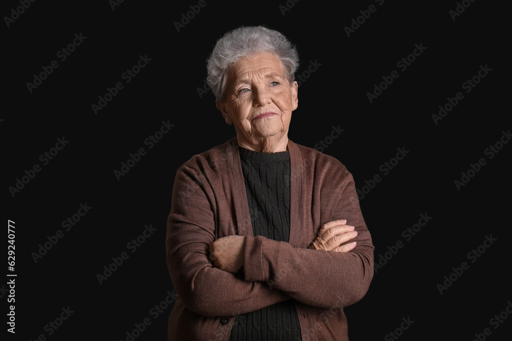 Senior woman on black background