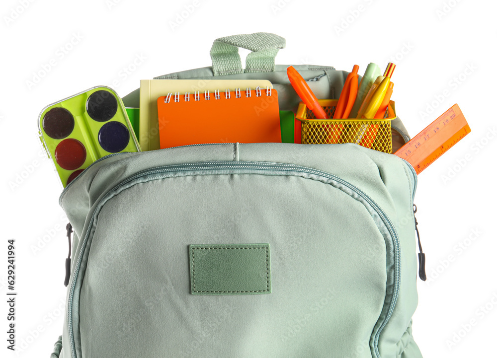 Green school backpack with different stationery on white background