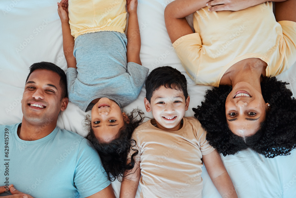 Top view, portrait and parents with children on bed for bonding, quality time and affection in morni