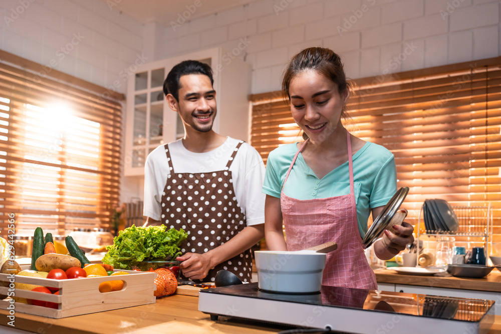 Asian young new marriage couple spend time together in kitchen at home. 