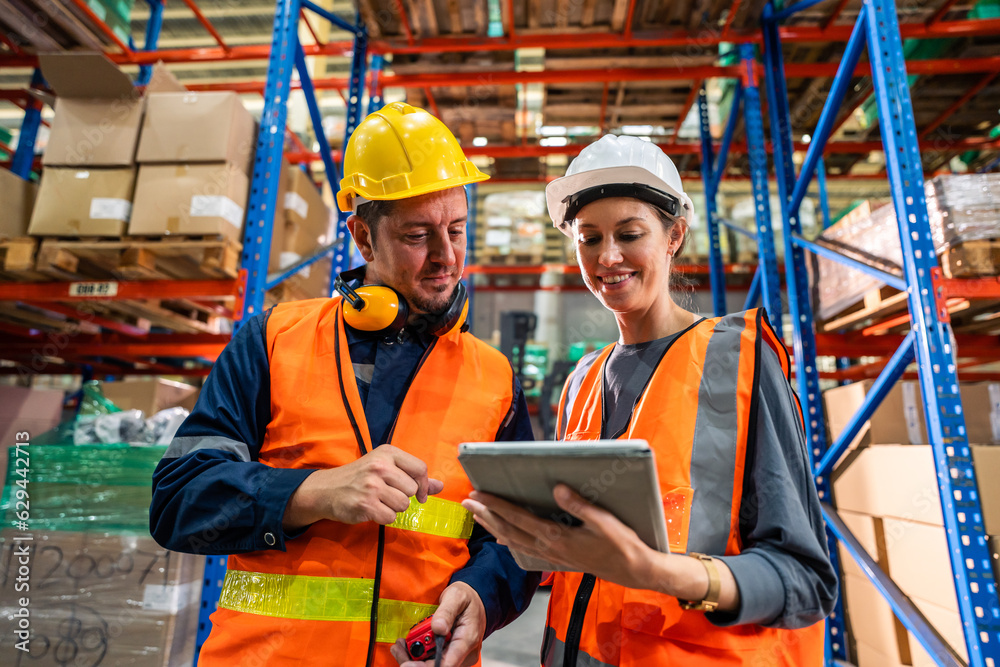 Caucasian man and woman industrial worker work in manufacturing plant. 