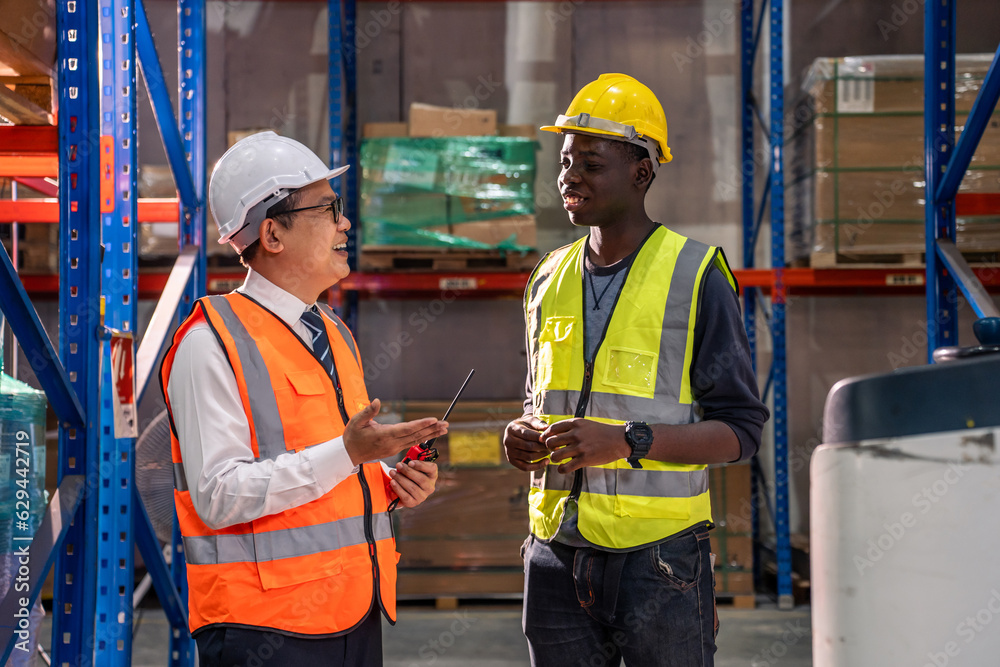 Diverse industrial worker team working in manufacturing plant together. 