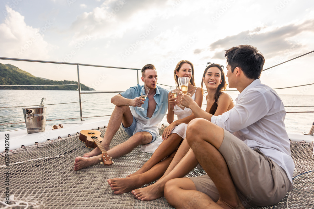 Group of diverse friends drink champagne while having a party in yacht.