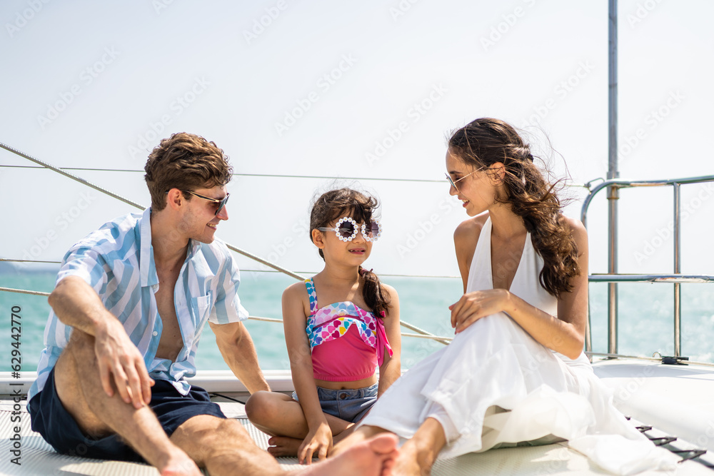 Caucasian happy family sitting on deck of yacht while yachting outdoor. 