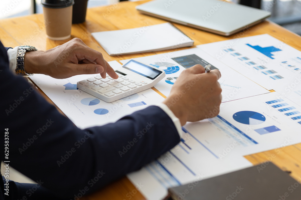 Businessman working on documents on the desk, data analysis of financial figures and business invest