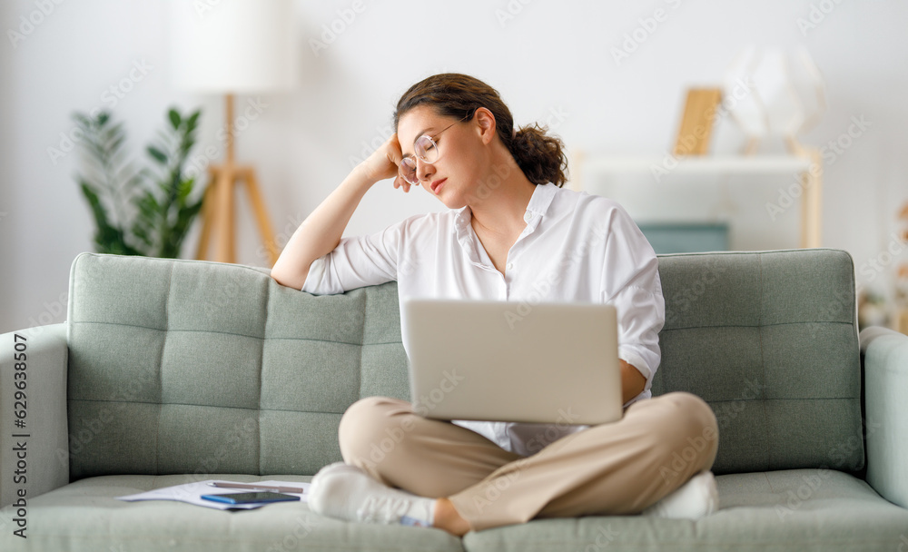 Tired woman working on laptop