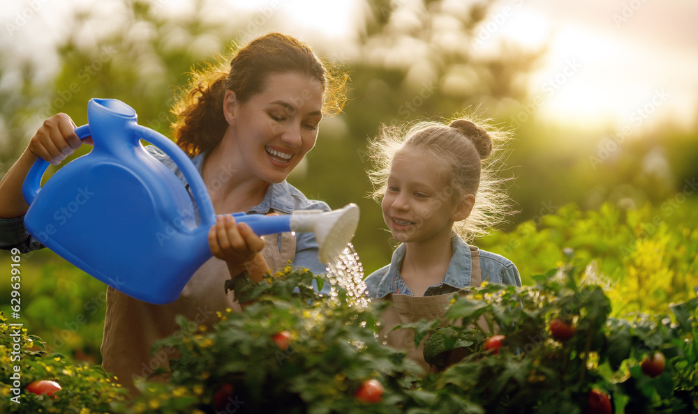 mother and daughter gardening in the backyard