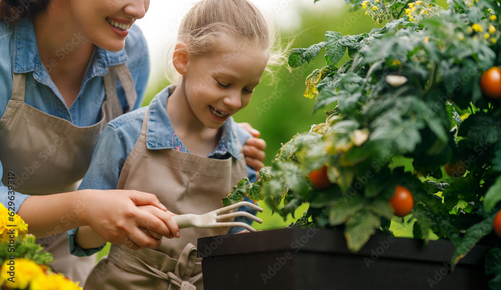 mother and daughter gardening in the backyard