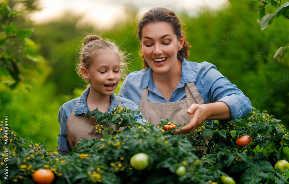 mother and daughter gardening in the backyard