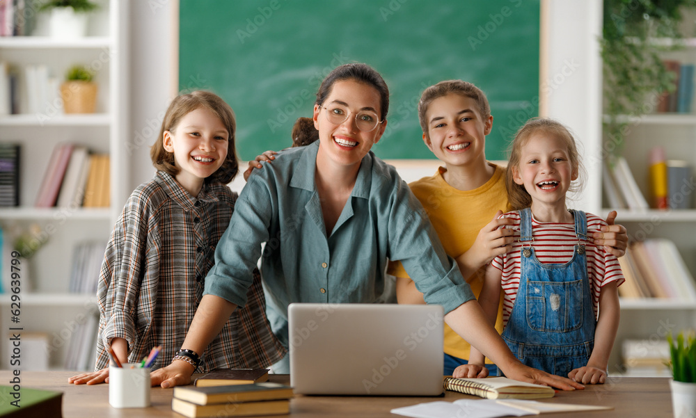 Happy kids and teacher at school