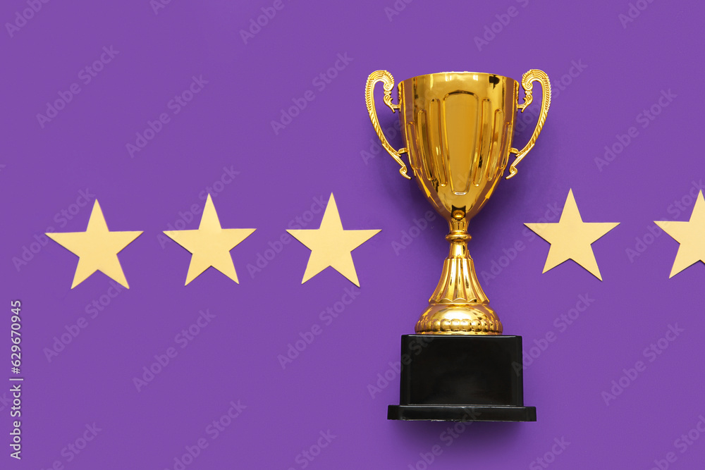 Gold cup with stars on purple background