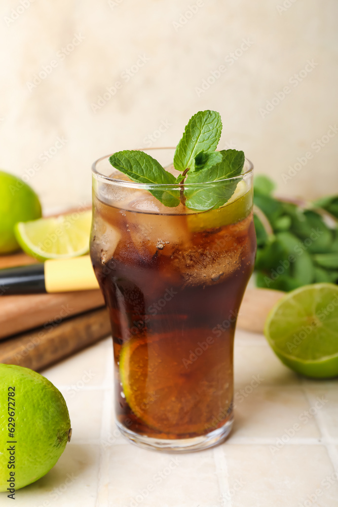 Glass of tasty Cuba Libre cocktail on table