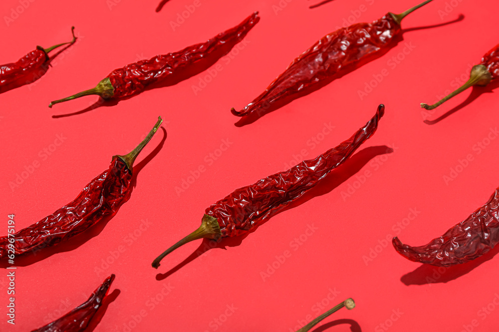 Dry hot chili peppers on red background