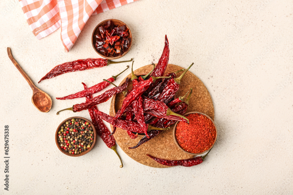 Composition with dry hot chili peppers and spices on white background