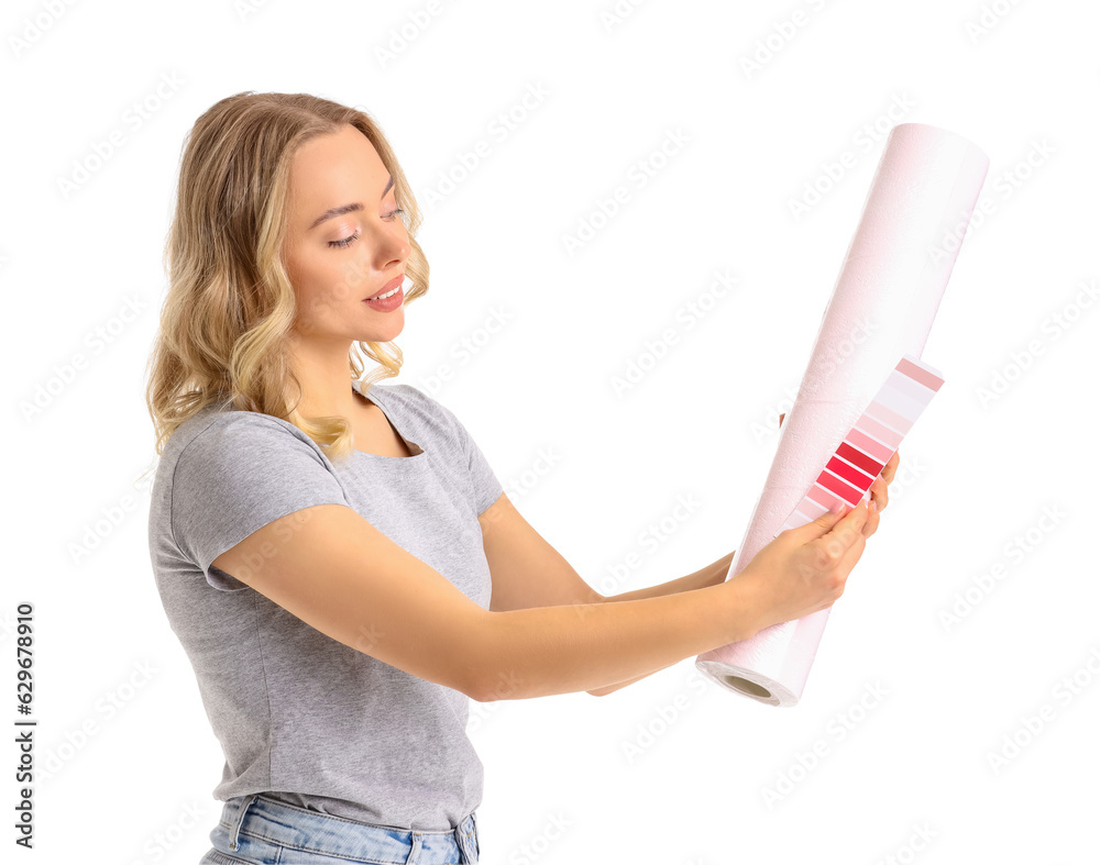 Young woman with wallpaper roll and paint color palette on white background