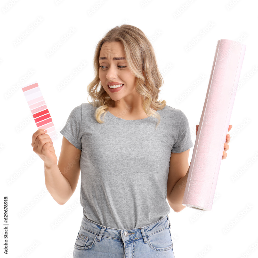 Young woman with wallpaper roll and paint color palette on white background