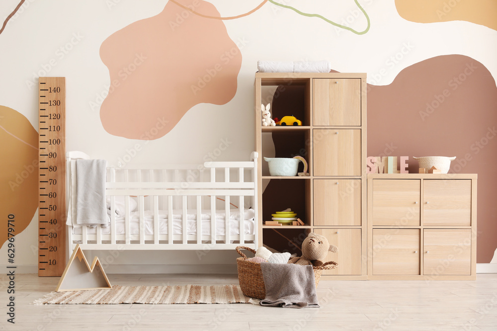 Interior of childrens bedroom with bed and shelving unit