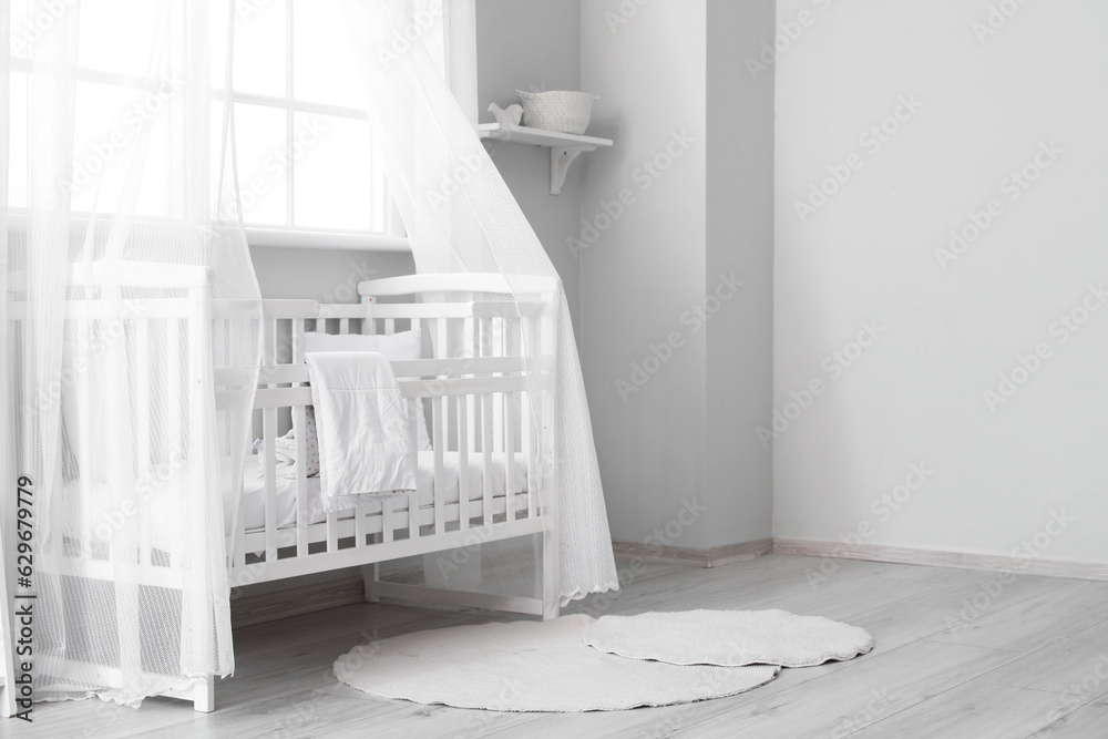 Interior of stylish childrens bedroom with crib