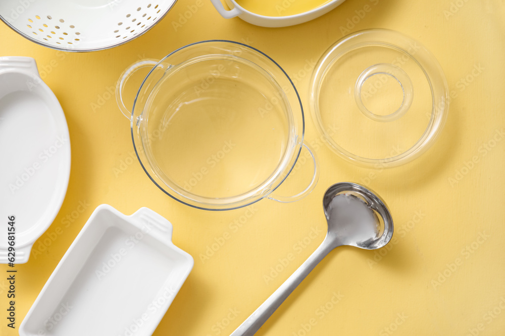 Set of different kitchen utensils on beige background