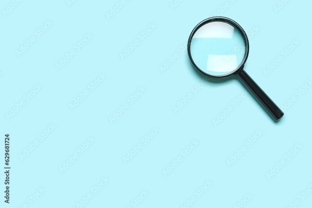 Black mini magnifier on blue background