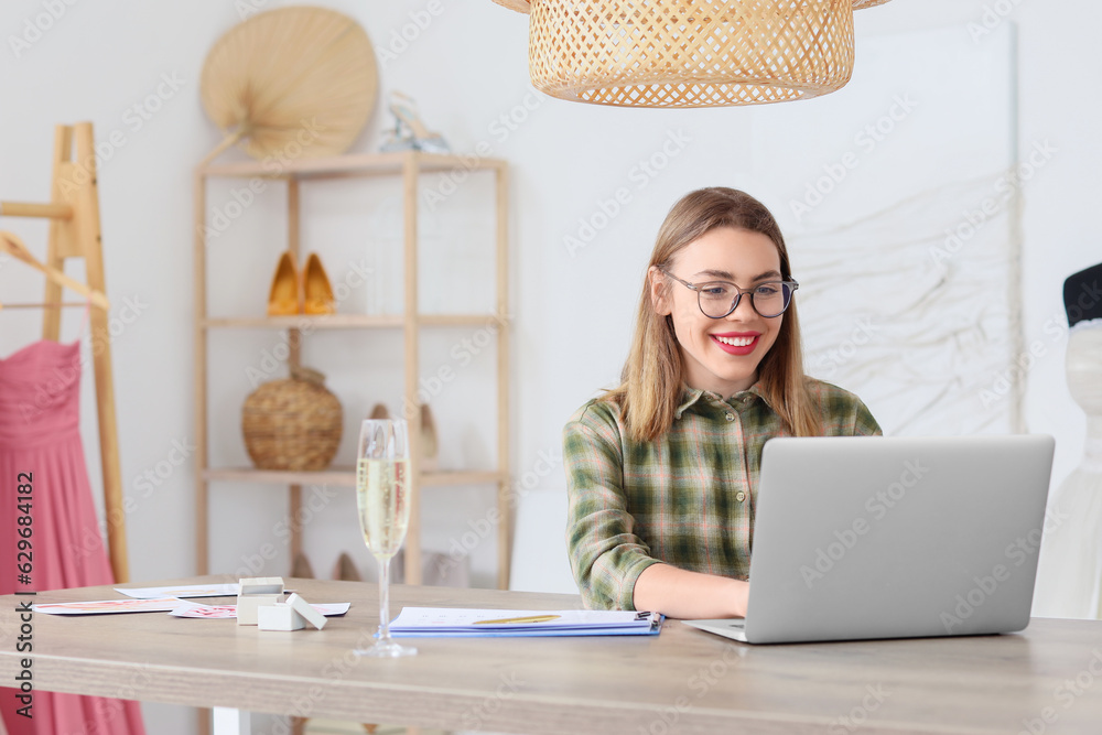 Female wedding planner working with laptop in office