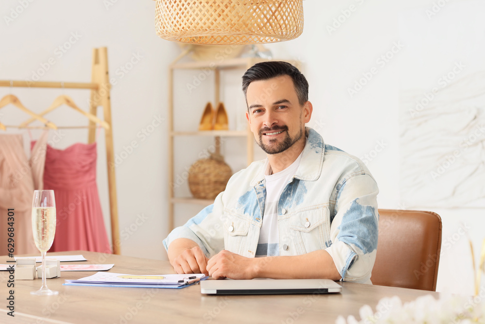 Male wedding planner working in office