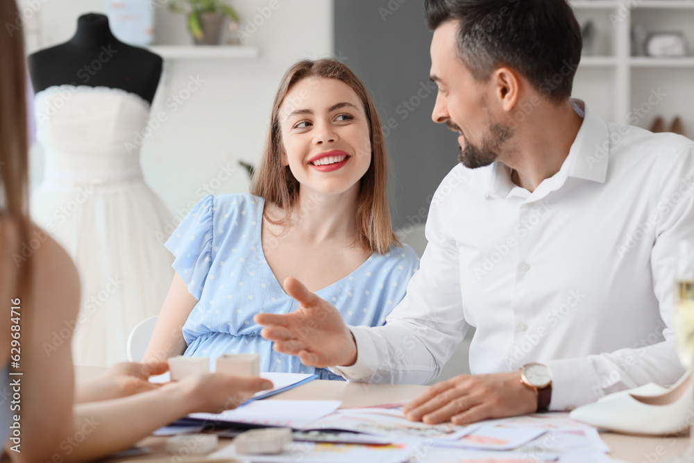 Young couple planning their wedding in office