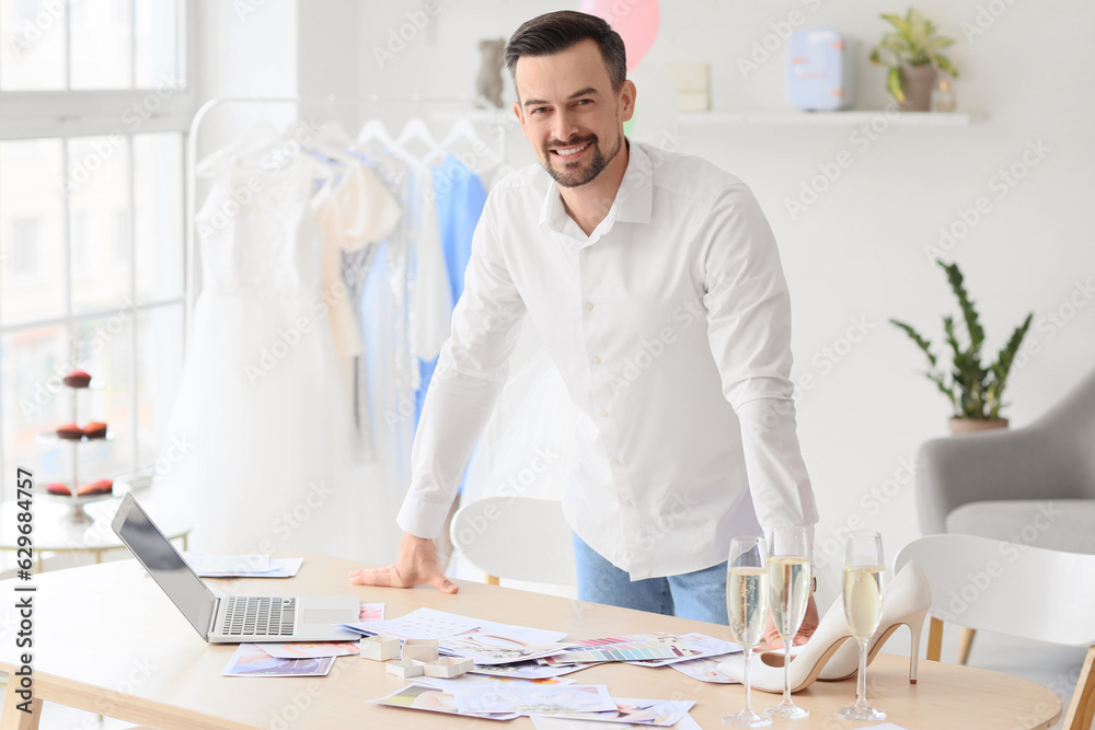 Male wedding planner working in office