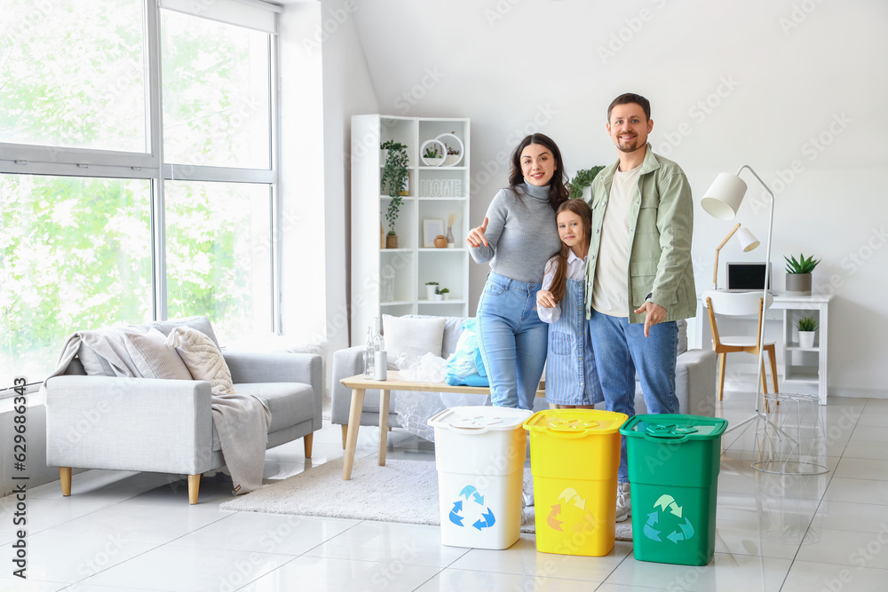 Family with recycle bins at home