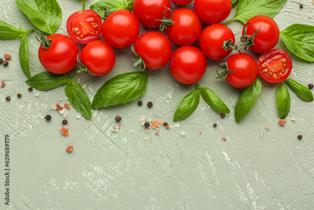 Composition with ripe cherry tomatoes, basil leaves and peppercorn on color background