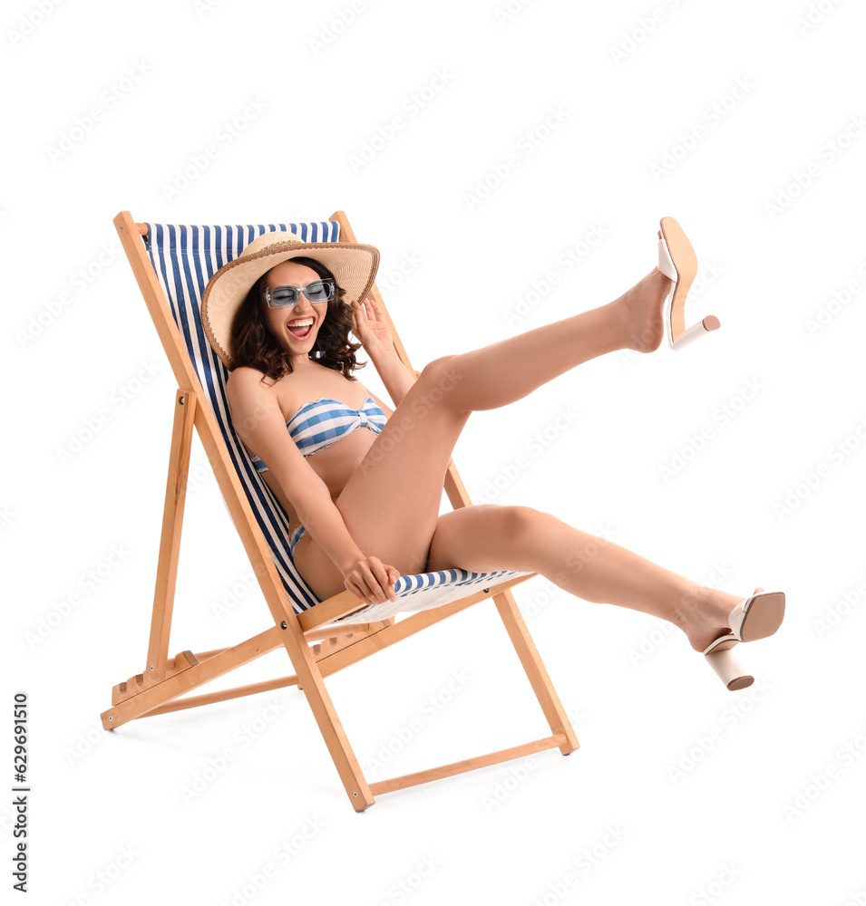 Young woman in deck chair on white background