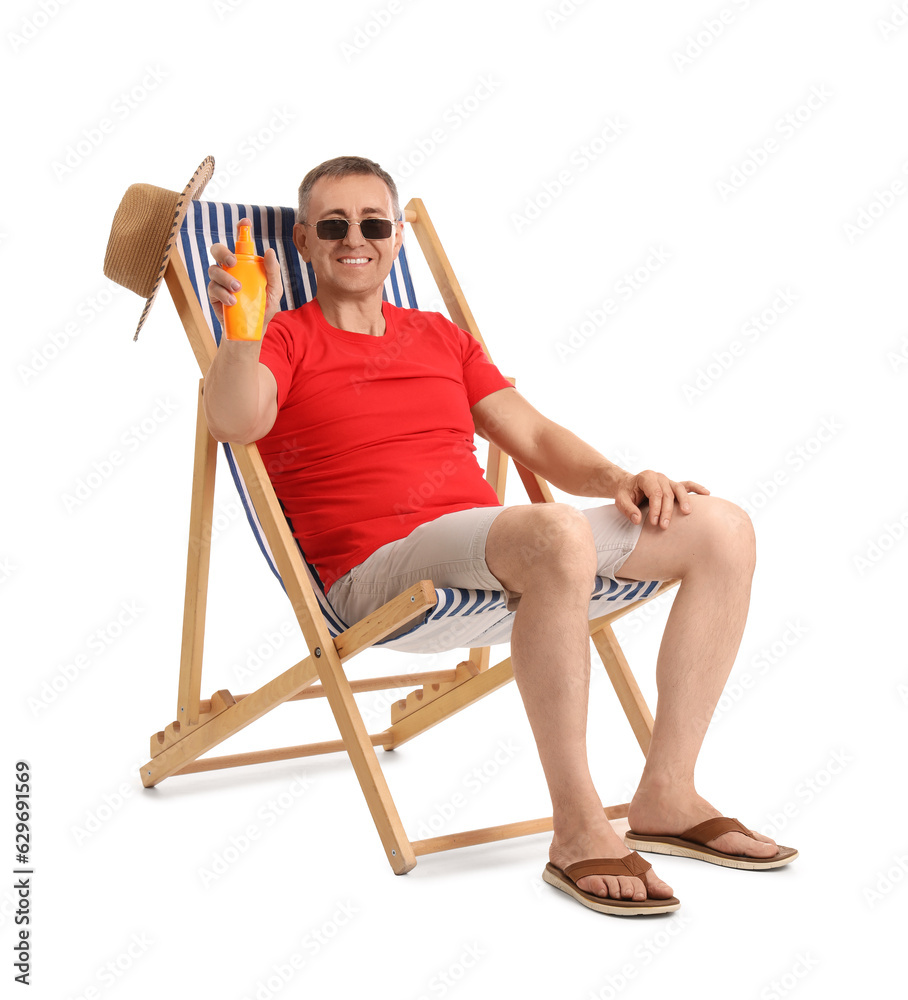 Mature man with sunscreen cream relaxing in deck chair on white background