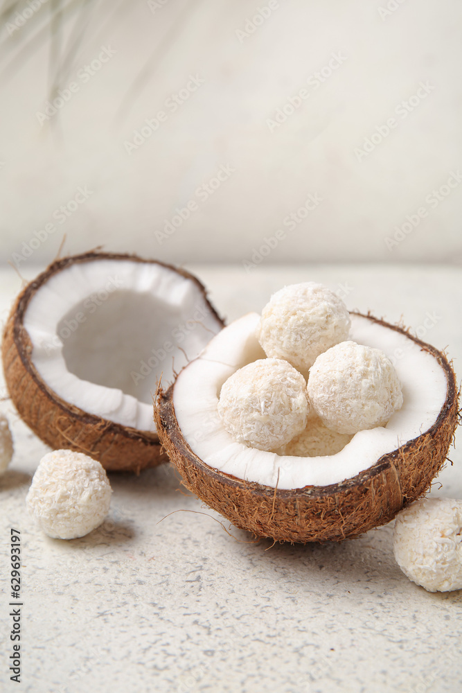 Coconut with white chocolate candies on light table