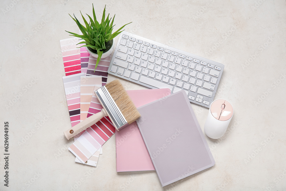 Many color palettes, PC keyboard, brush and notebooks on light background, top view