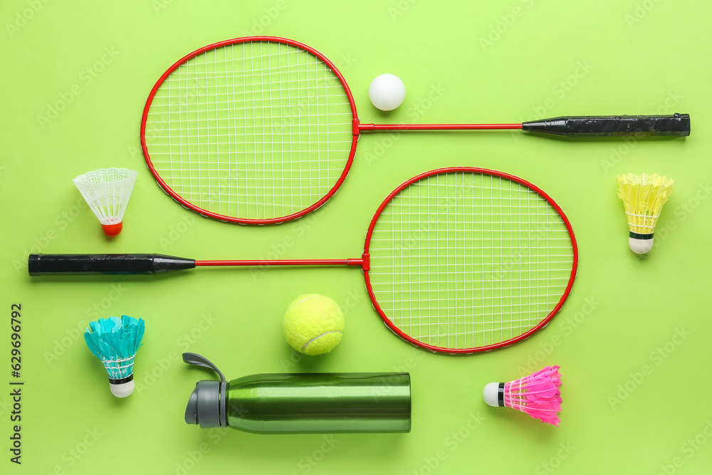 Composition with sports equipment on green background