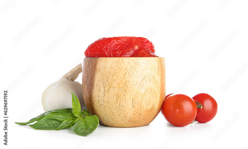 Bowl of canned tomatoes and garlic on white background