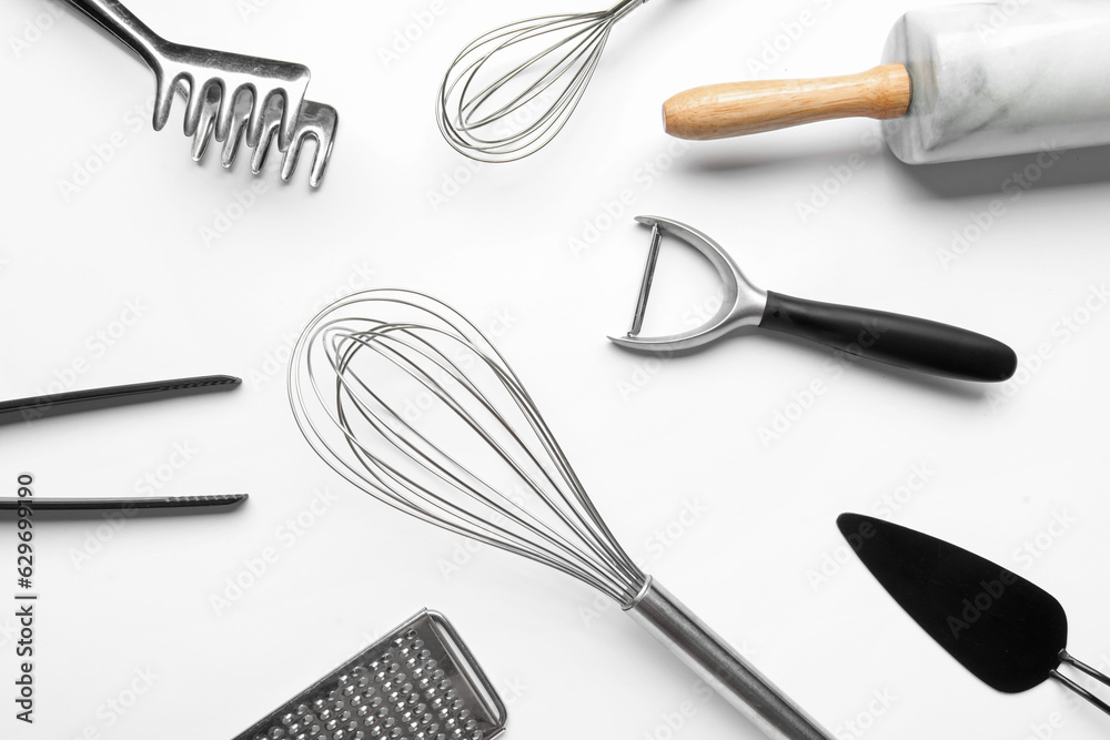 Composition with different kitchen utensils on light background