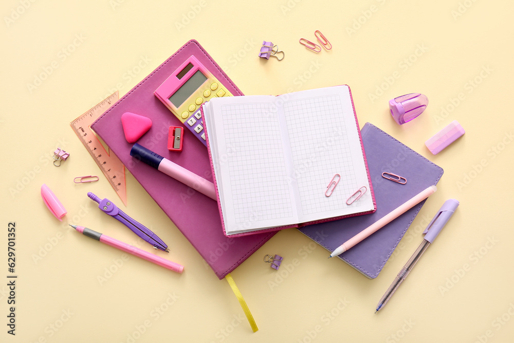 Different school stationery and notebooks on beige background