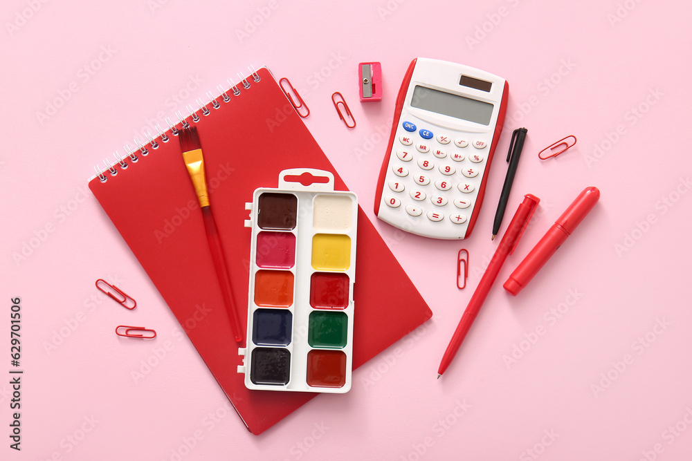 Different school stationery and notebook on pink background