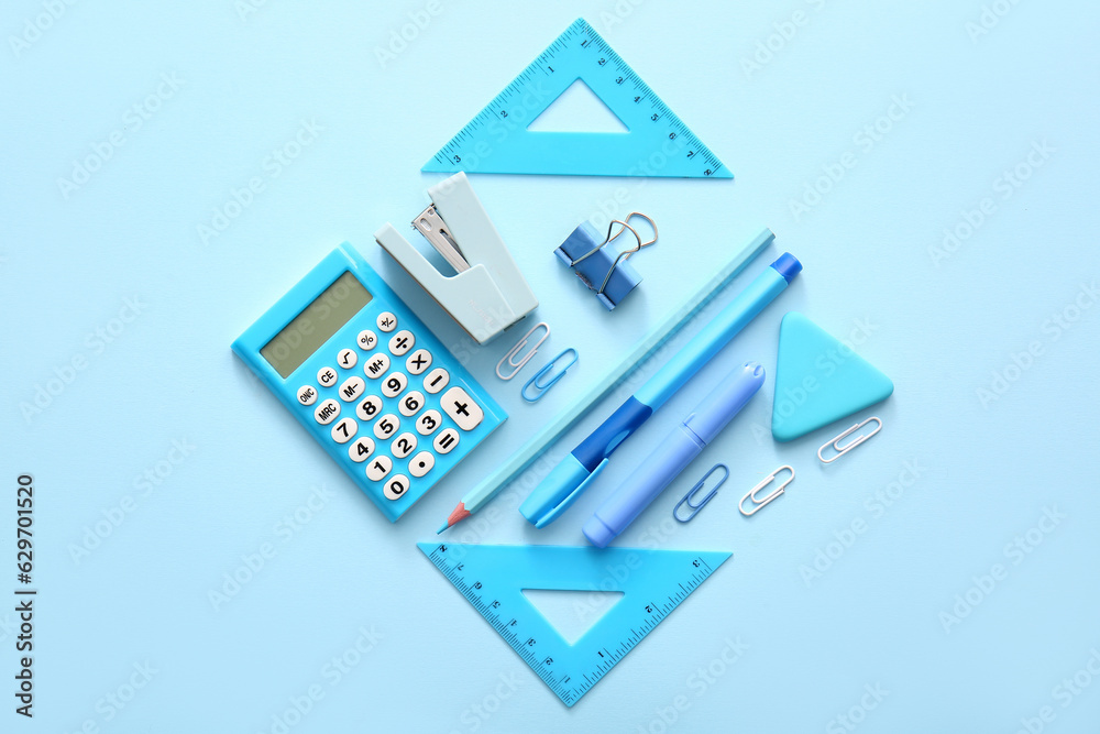 Different school stationery on blue background