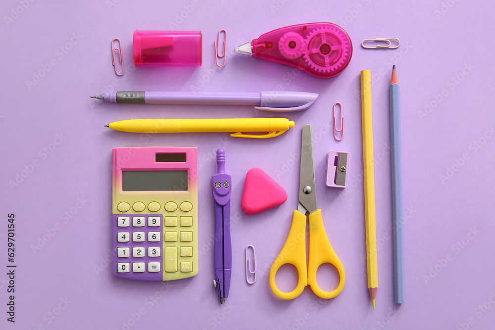 Different school stationery on purple background