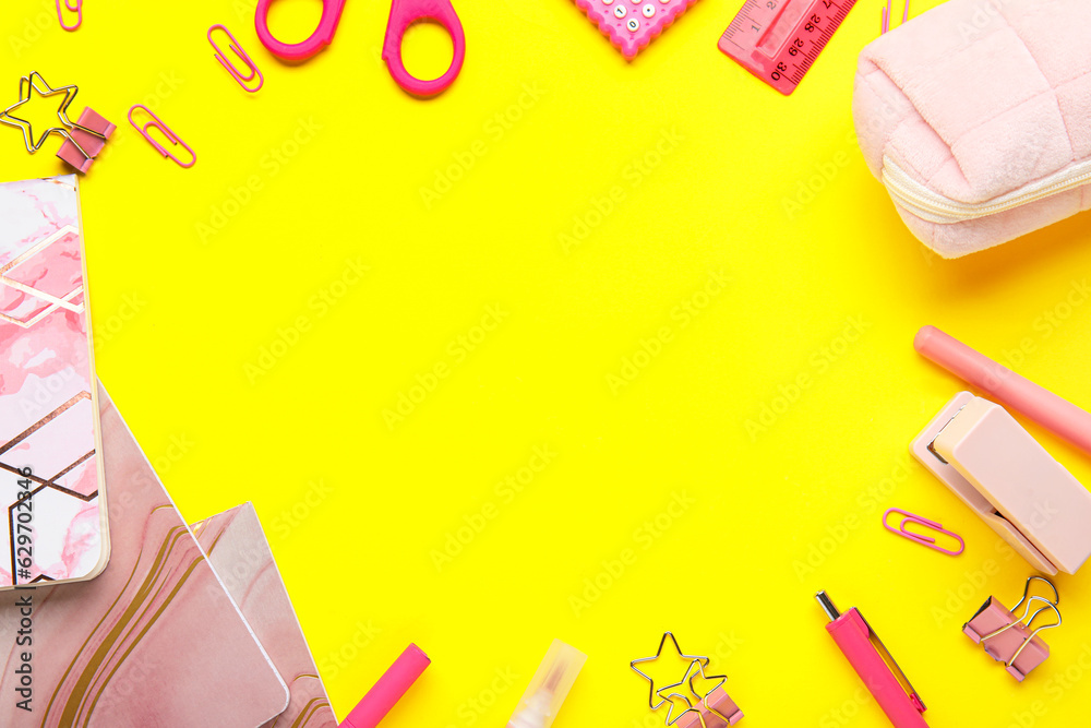 Frame made of colorful stationery on yellow background, closeup