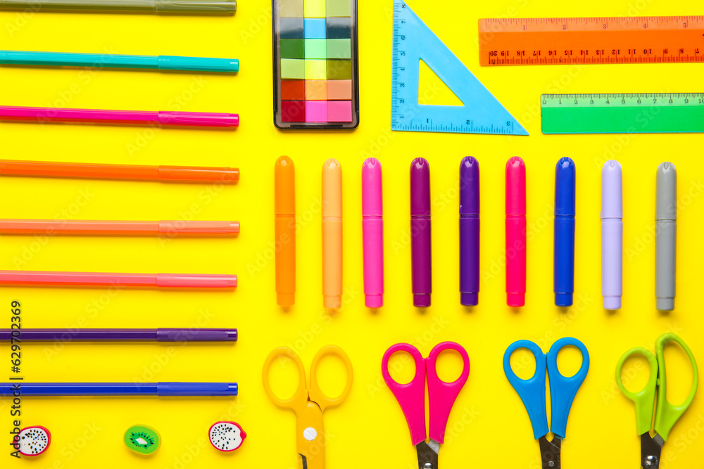 Composition with different colorful stationery on yellow background