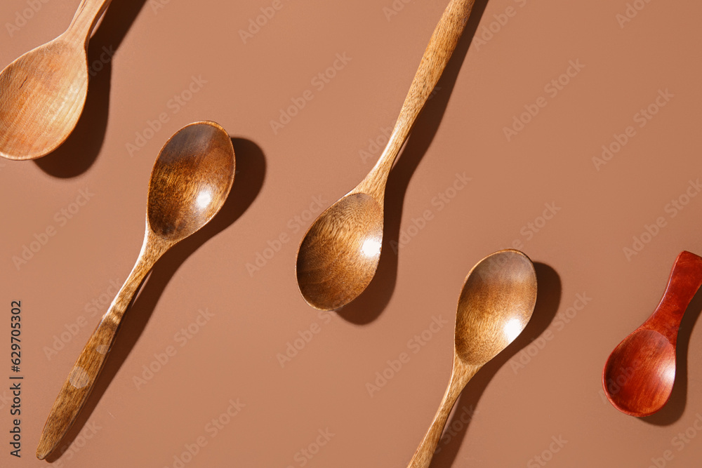 Set of wooden spoons on color background