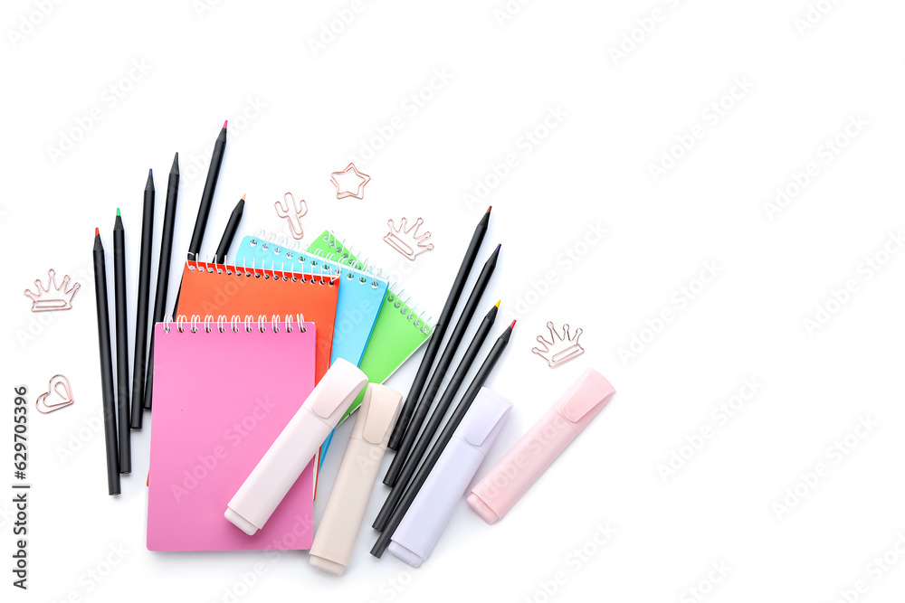 Notebooks and school stationery on white background