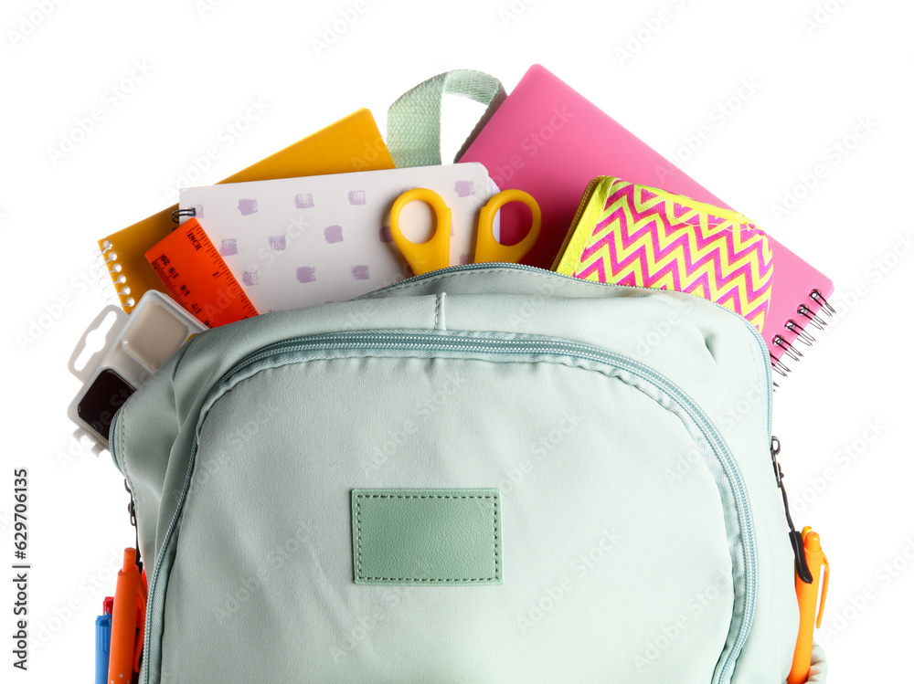 Green school backpack with notebooks, pencil case and scissors on white background