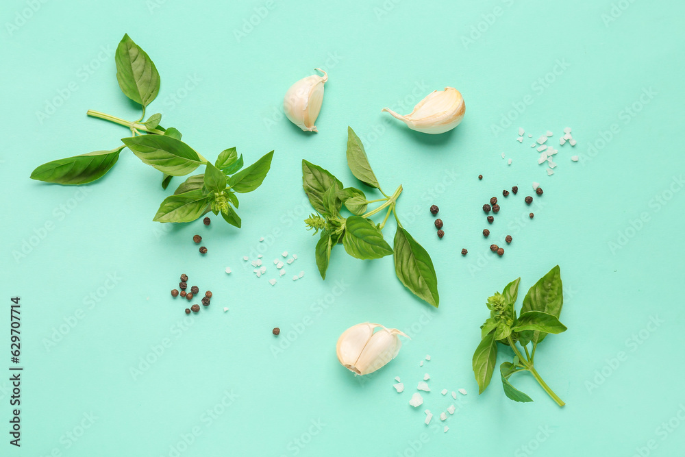 Composition with fresh basil and spices on color background