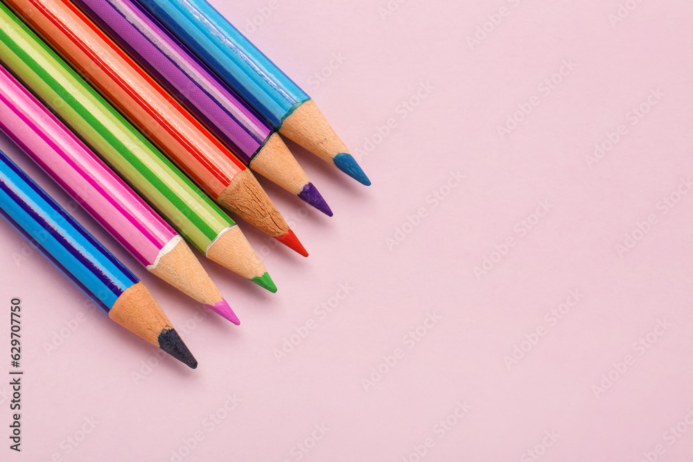 Set of colorful pencils on pink background, closeup