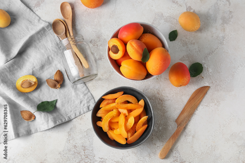 Bowl with pieces of sweet apricots on white table